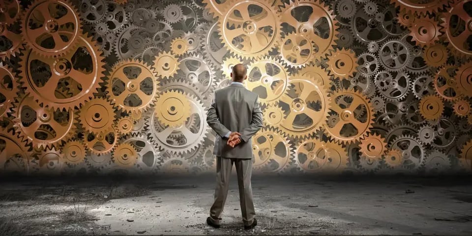 Back view of businessman looking at mechanism of cogwheels-1
